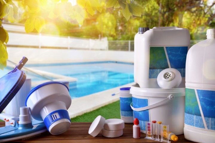Poolside skincare and sunscreen products with a swimming pool in the background