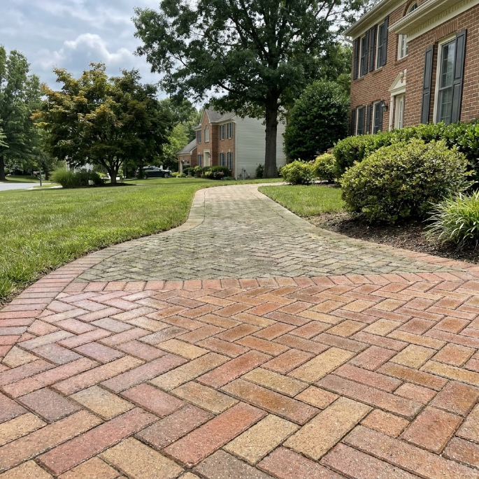 Brick front steps with a curved lower step leading to a purple front door and porch benches