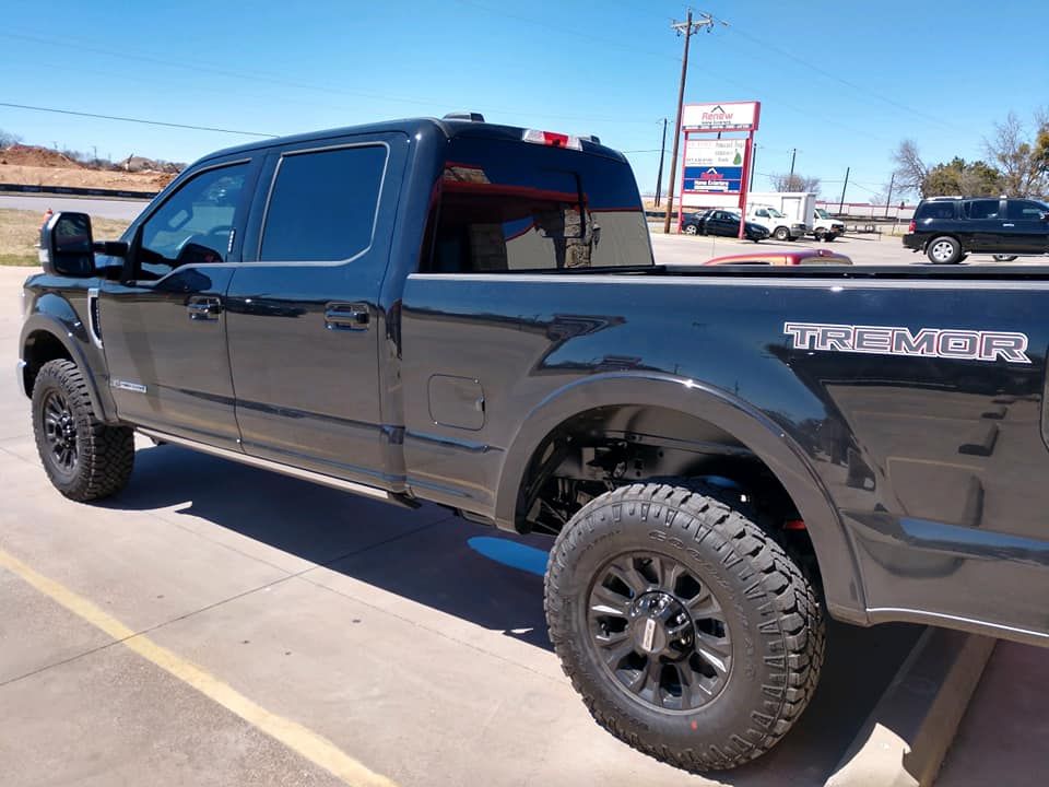 Black Ford F-Series Tremor truck parked outside on a sunny day.