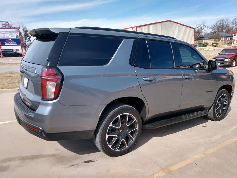 Gray Chevrolet Tahoe SUV parked outside on a sunny day.