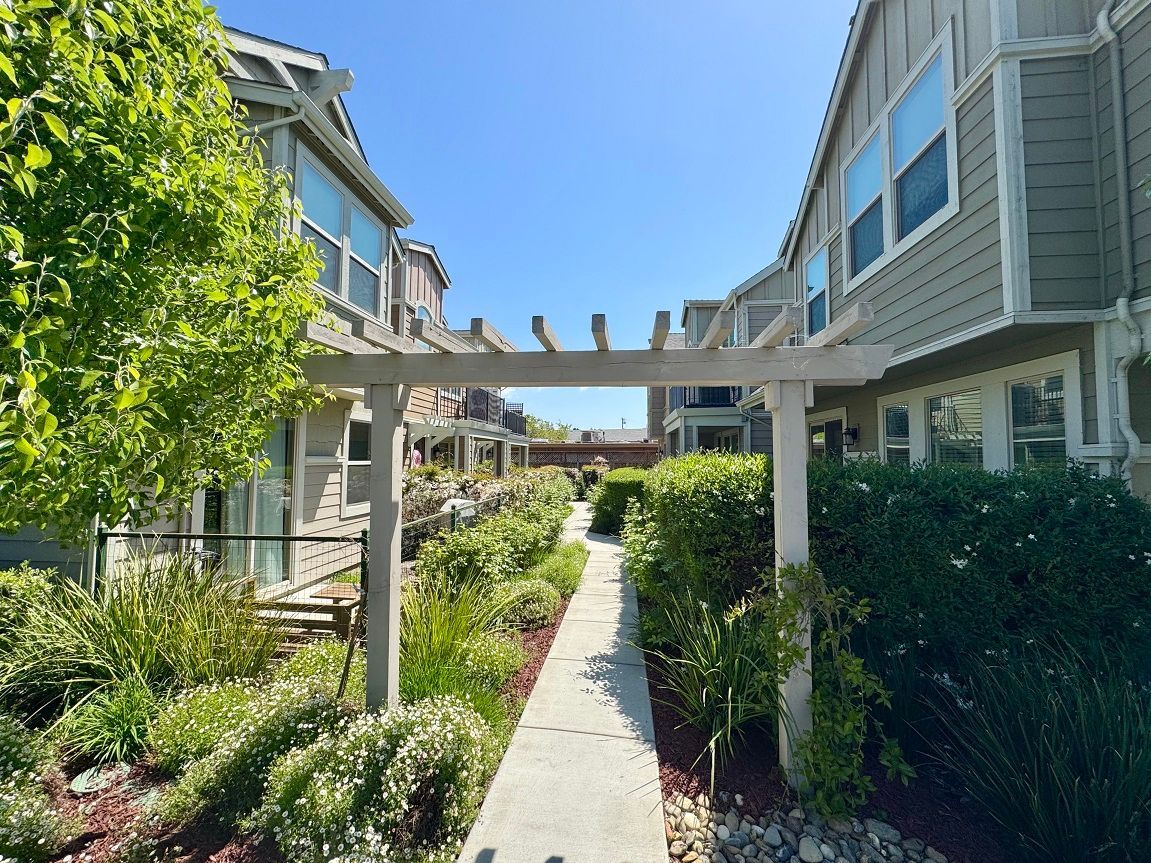 A row of apartment buildings with a walkway between them