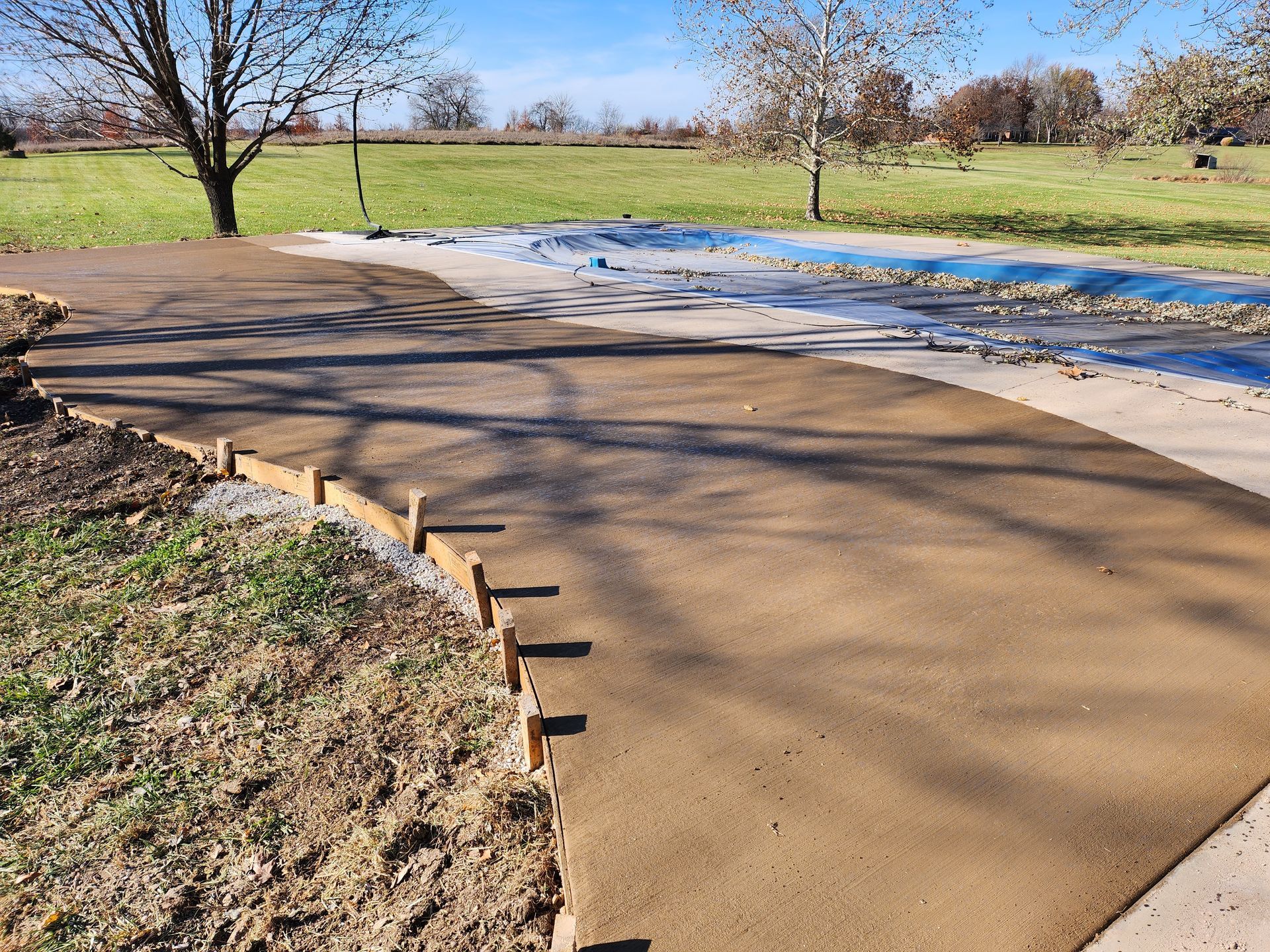 A concrete driveway is being built in a park.