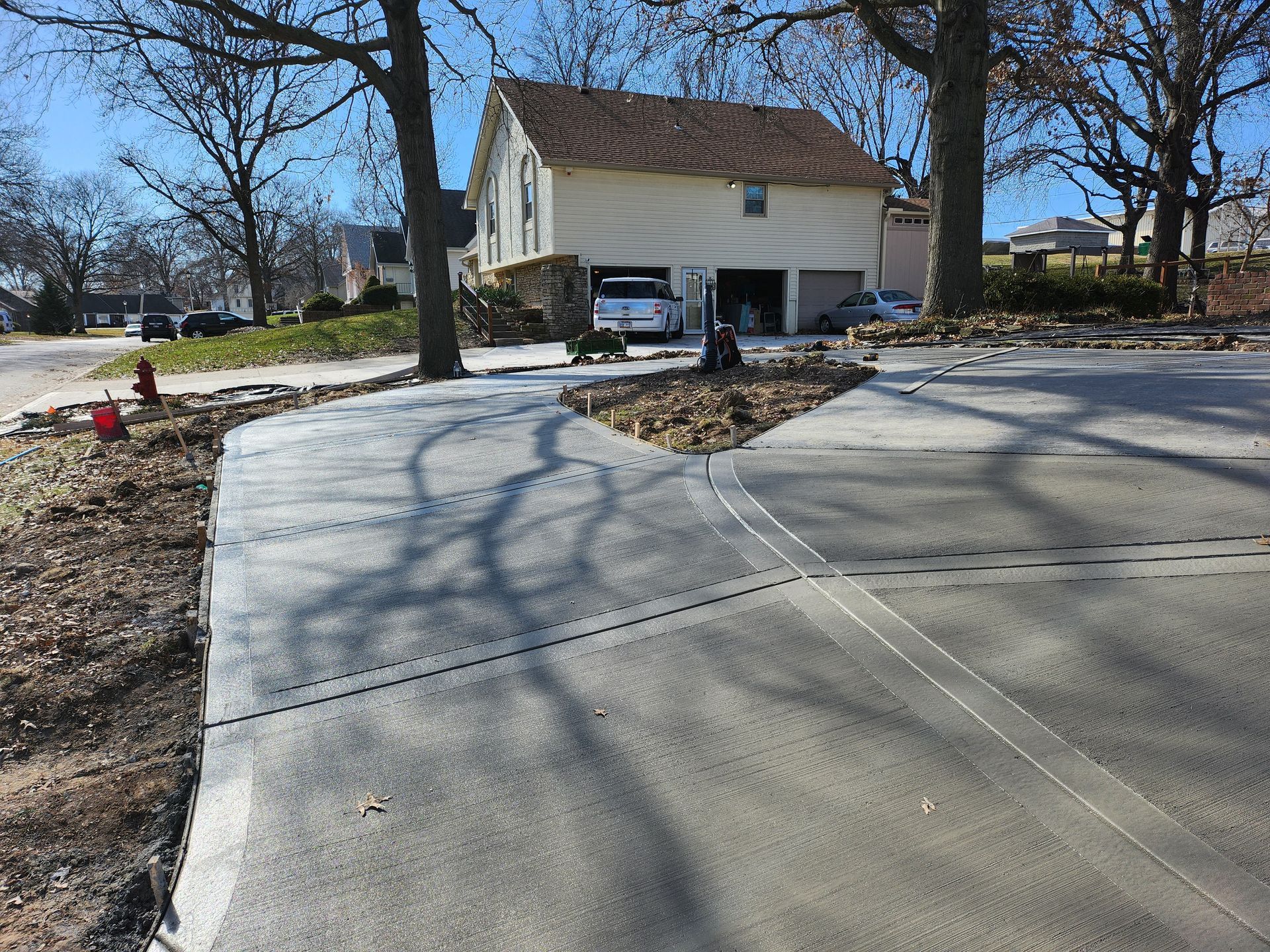 A concrete walkway is being built in front of a house