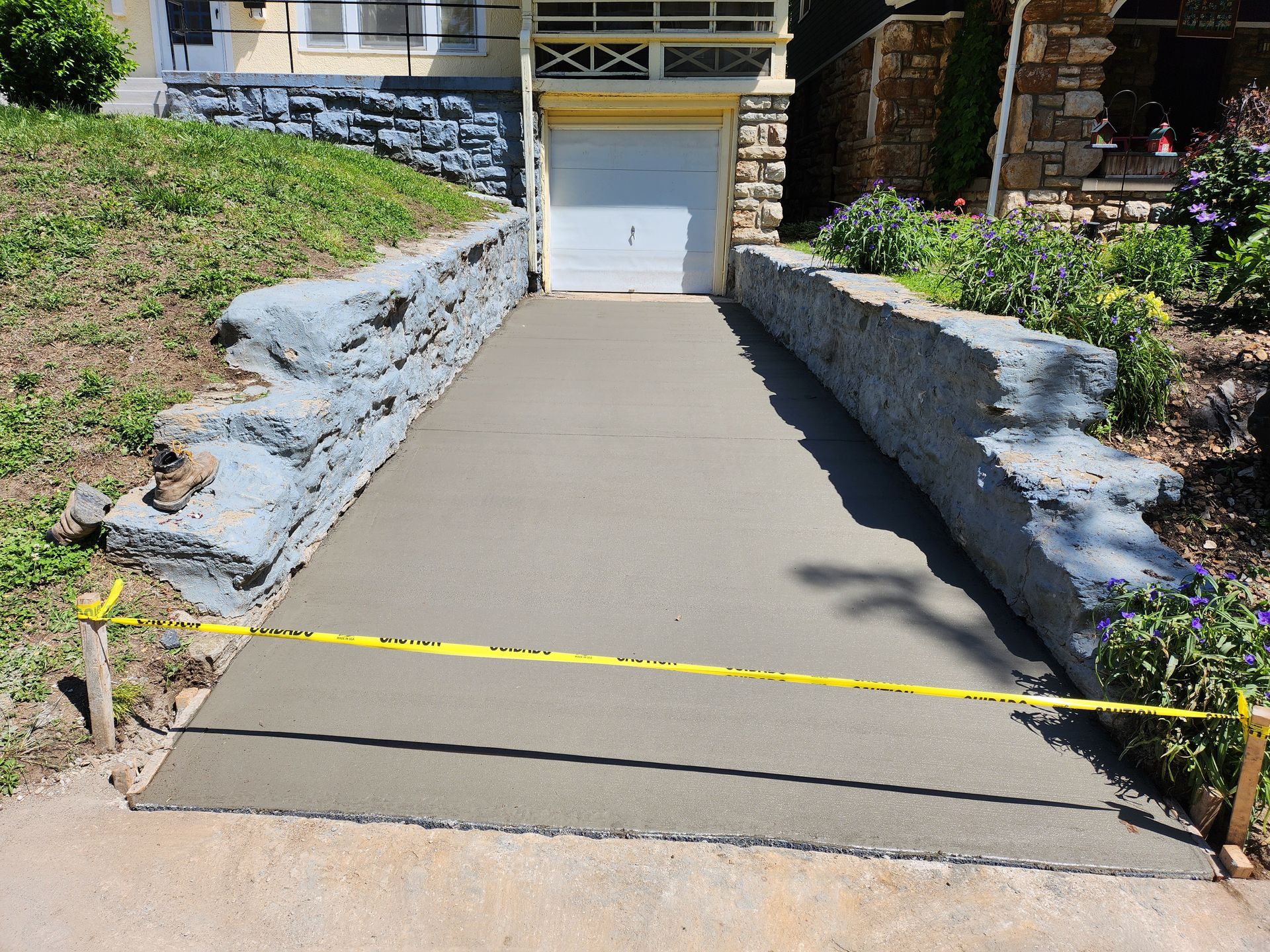 A concrete driveway is being built in front of a house