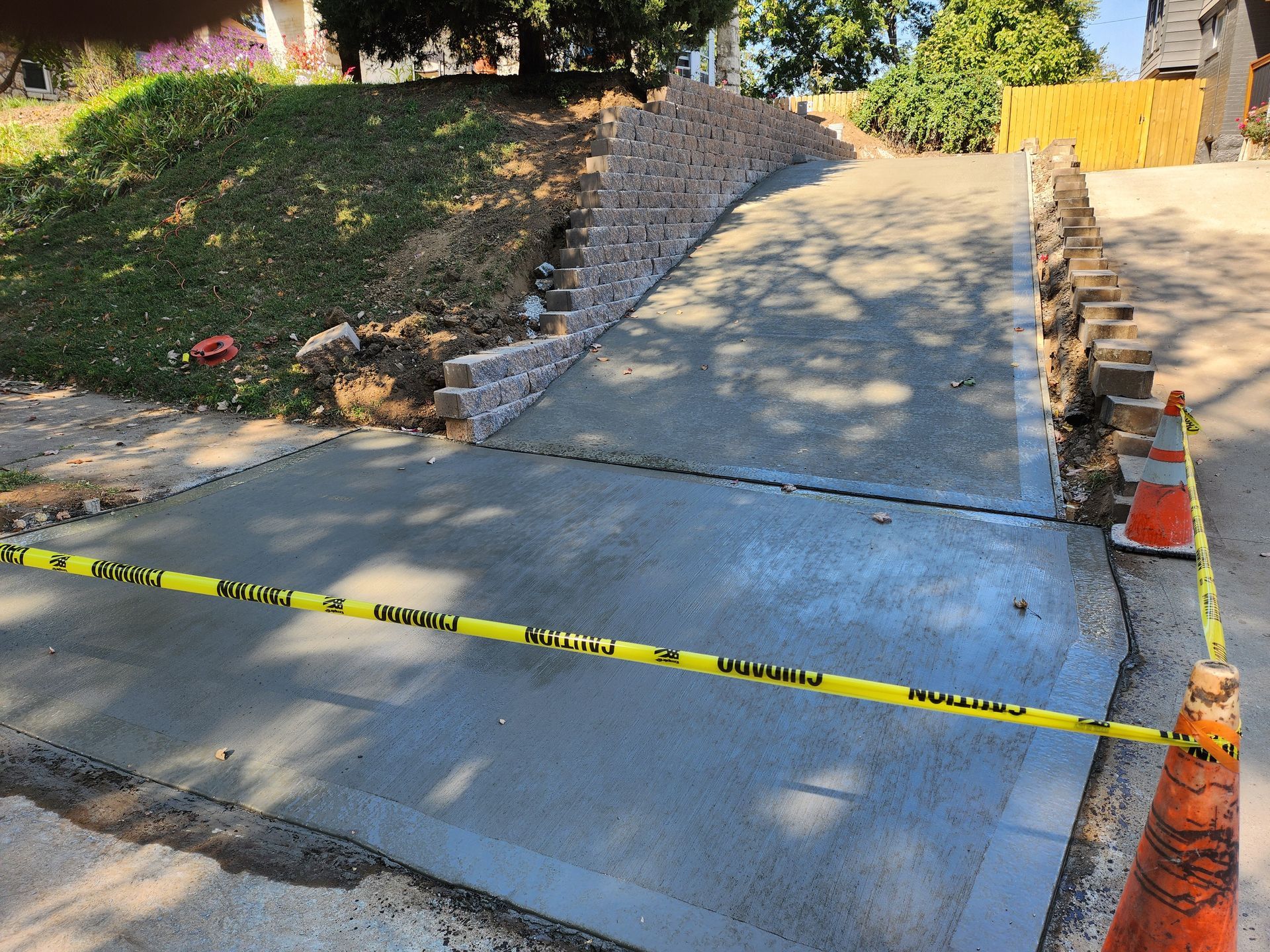 A concrete driveway is being built in front of a house.