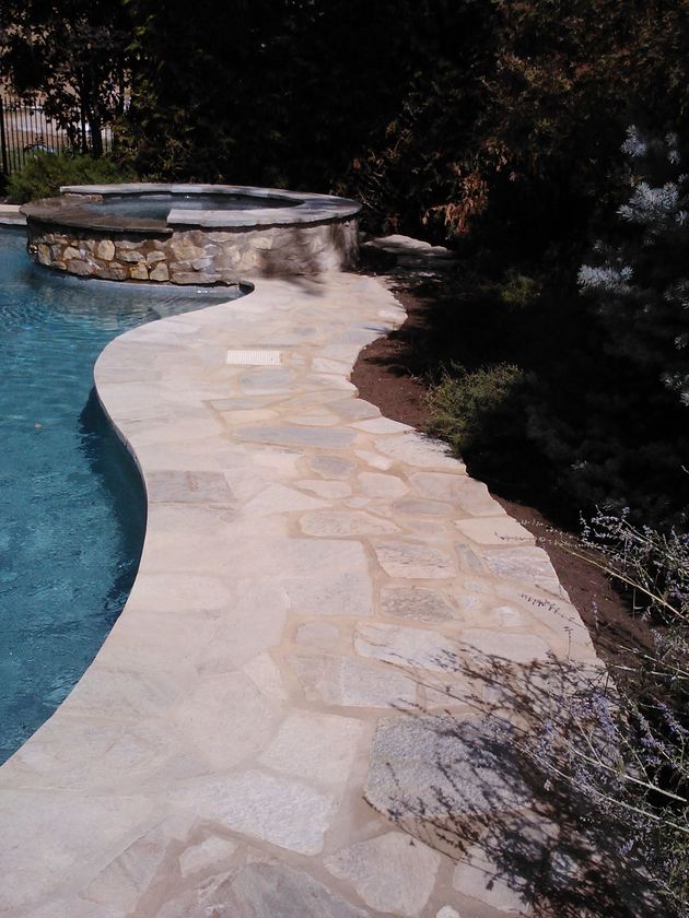 A swimming pool with a stone walkway leading to it