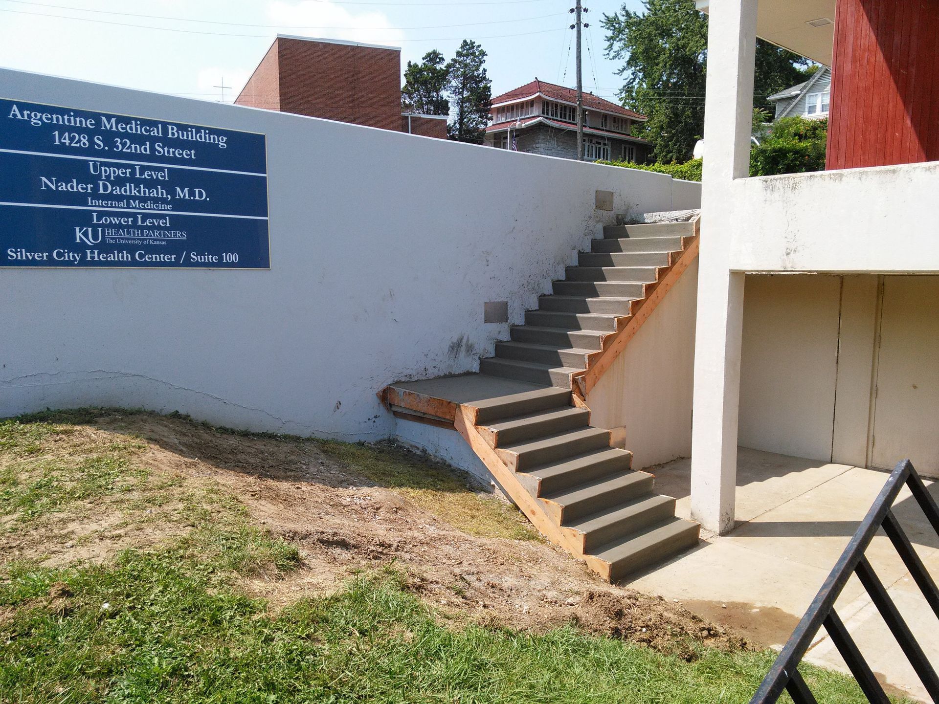 Stairs leading up to a building with a sign on it