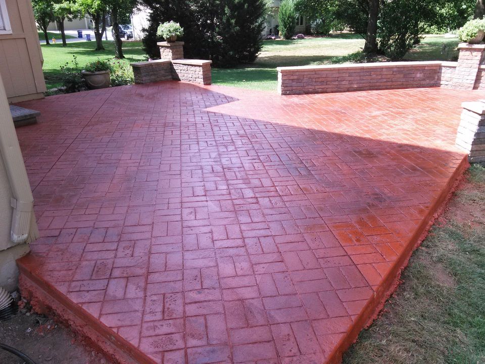 A red brick patio with a brick wall in the background