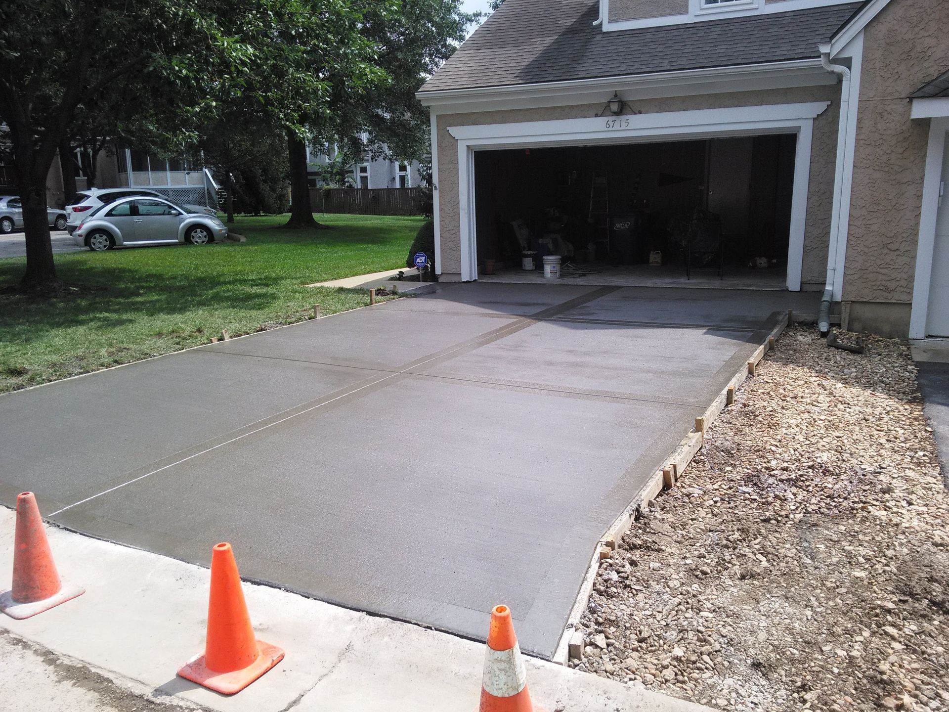 A concrete driveway is being built in front of a house