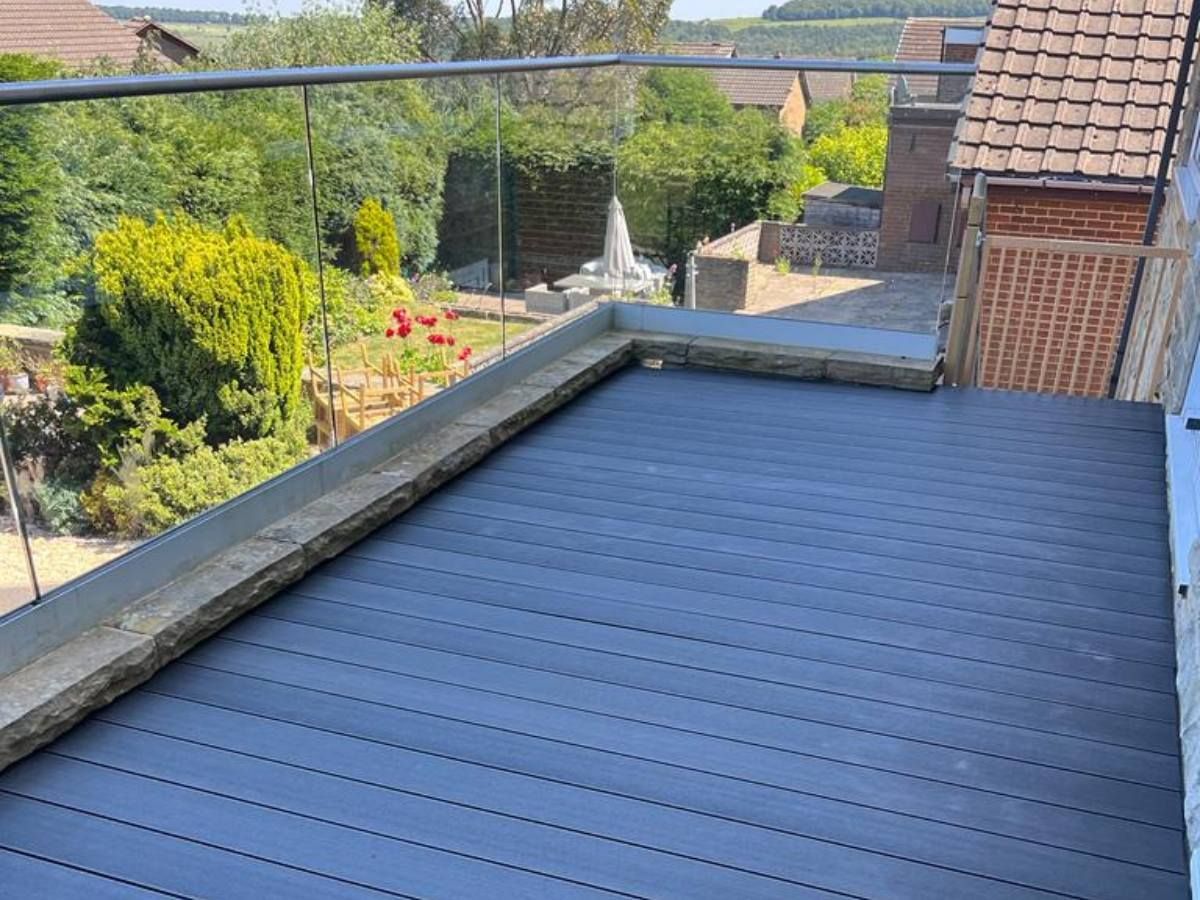 Composite Gates UK Composite decking and glass balustrade to create a flat roof balcony