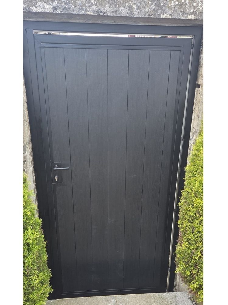 Anthracite grey composite pedestrian gate fitted in a stone opening