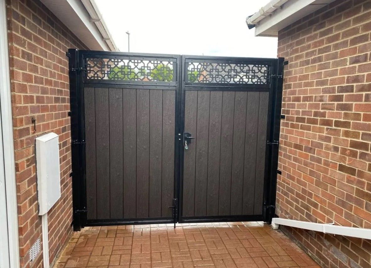 Chocolate composite driveway gates with trellis topper installed in
Cheltenham
