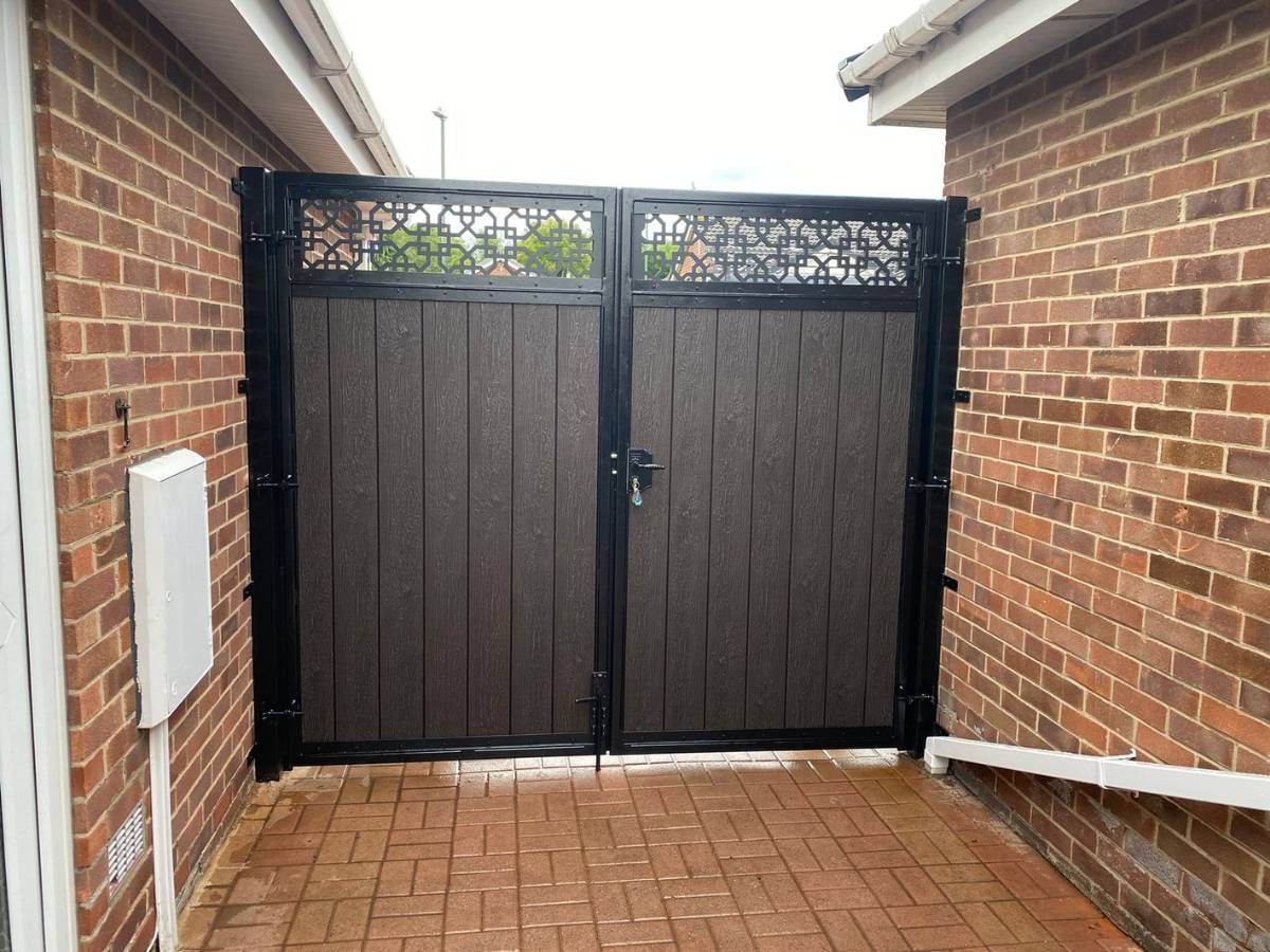 Chocolate composite driveway gates with trellis topper installed in
Guildford