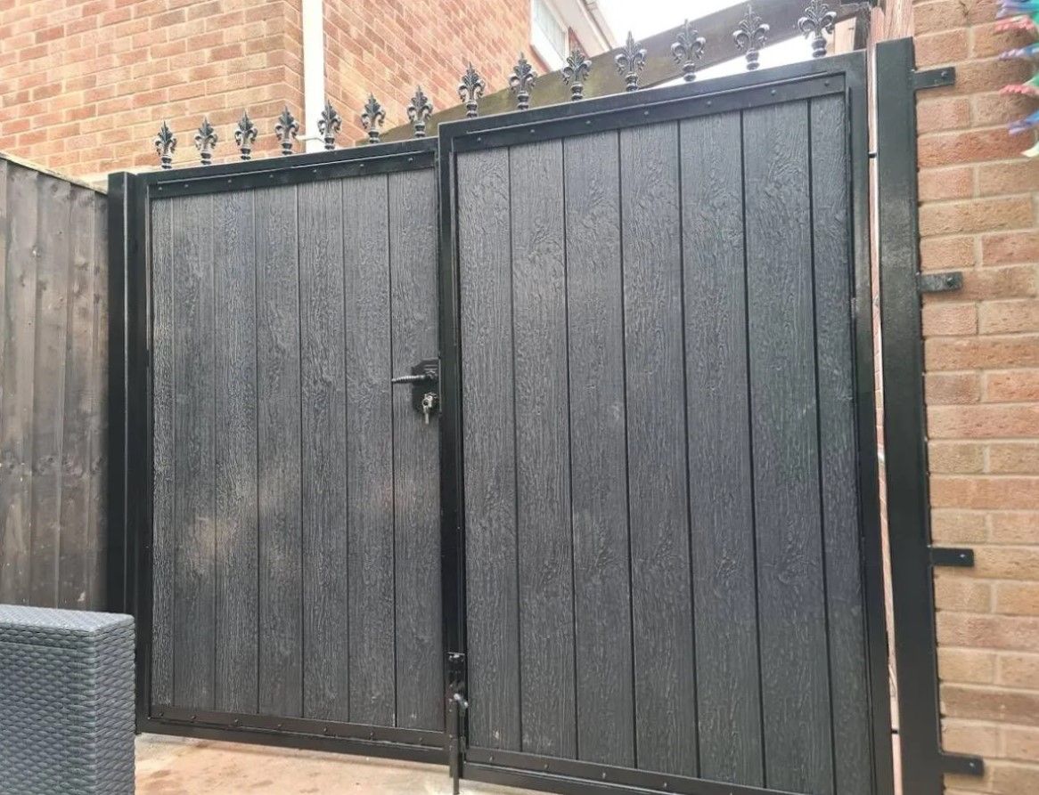 Composite driveway gates with fleur de lis finials