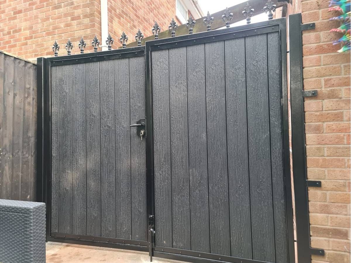 Composite driveway gates with fleur de lis finials in Dudley
