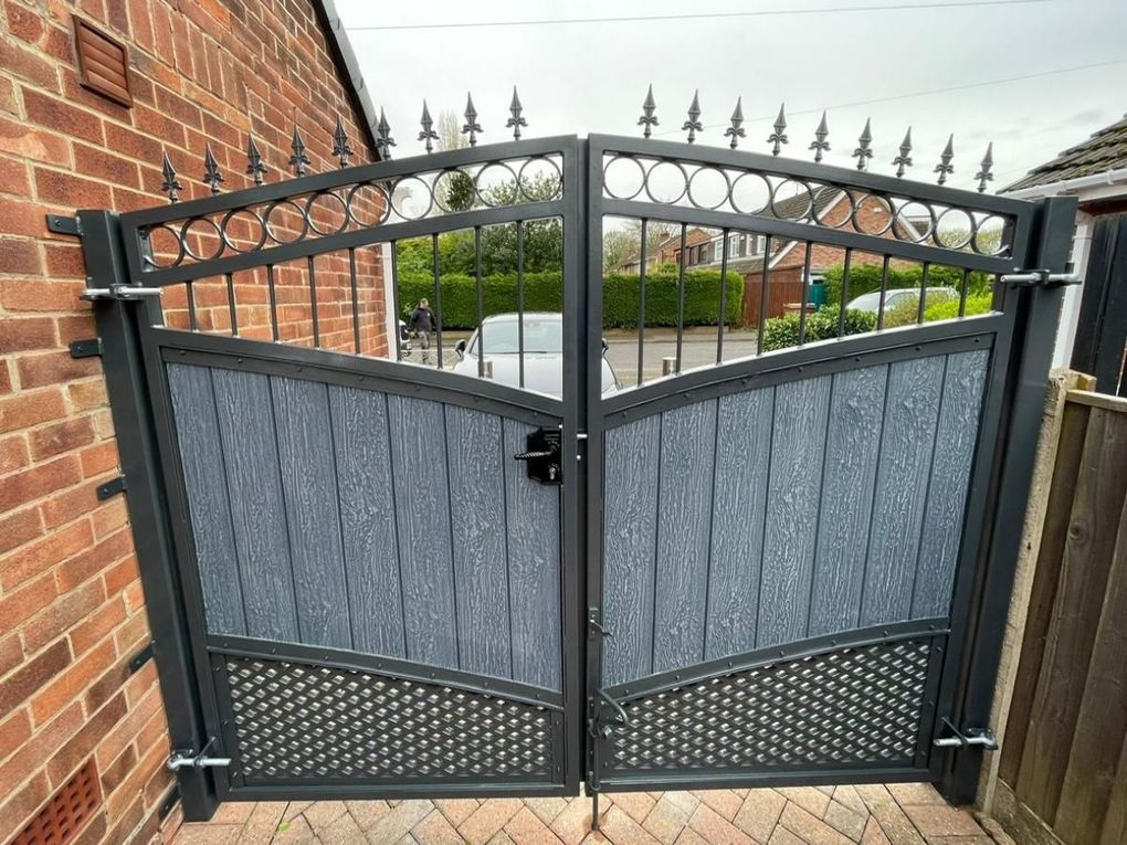Composite gates with a scrolled top section, mesh infill below and stainless steel pull handles