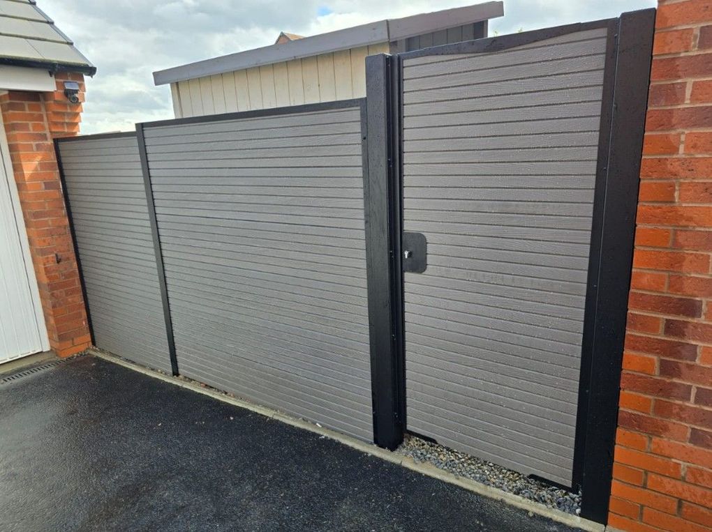 Grey composite pedestrian gate with matching composite fence panels alongside