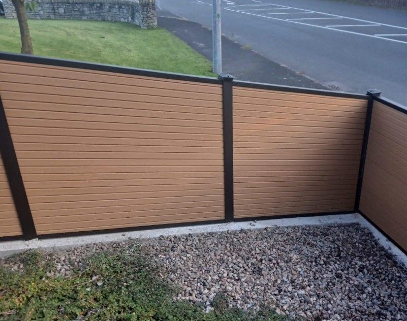 Composite Gates UK natural timber composite fencing installed in a sloping garden in Stoke on Trent