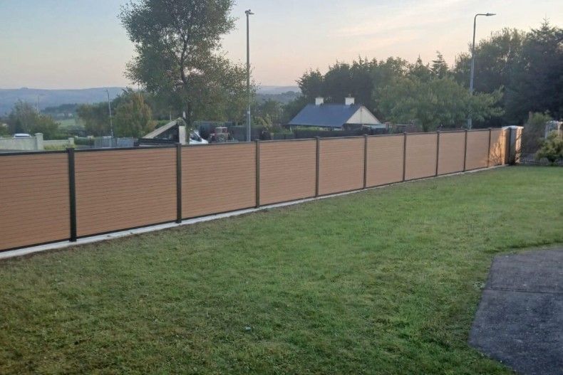 Composite Gates UK natural timber composite panel fence with black fence posts in Peterborough