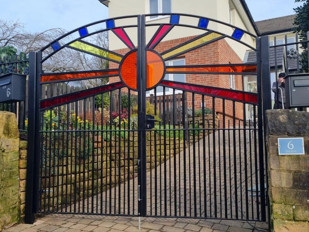 Perspex filled arched metal driveway gates Bristol