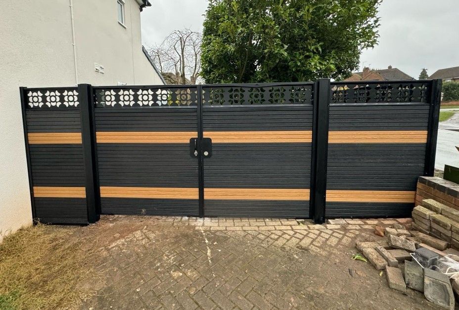 Two-tone composite driveway gates in anthracite and timber-effect bands with a decorative screen top