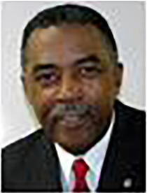 A man in a suit and tie is smiling for the camera.