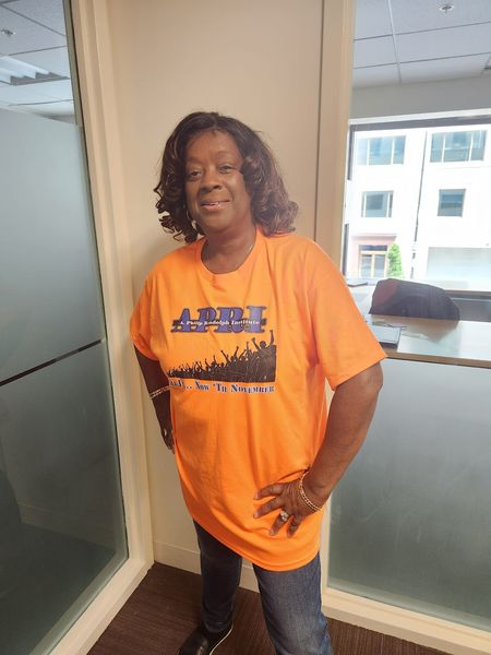 APRI member with orange shirt front