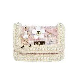 A purse with a flower and pearls on it.