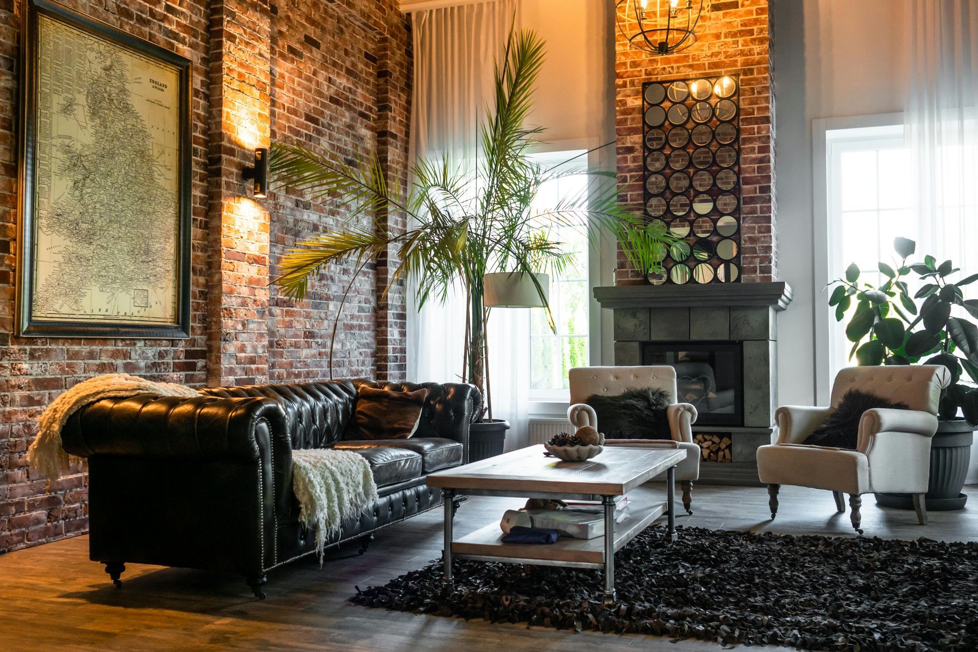 A living room with a couch , chair , coffee table and fireplace.
