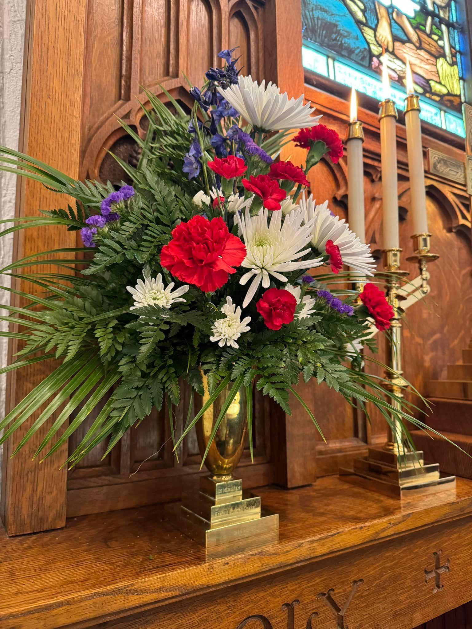 altar flowers with lit candles