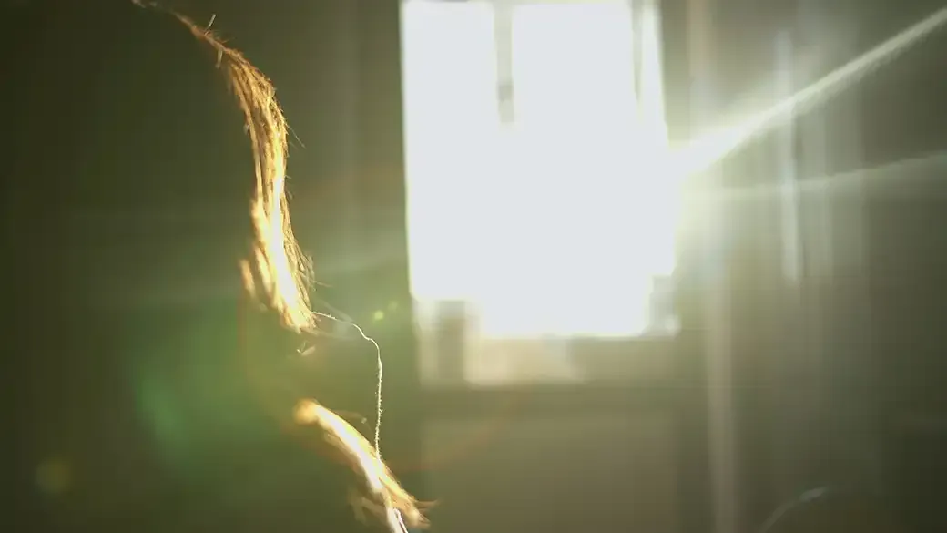 Woman Silhouette Standing by Bright Window with Sunlight