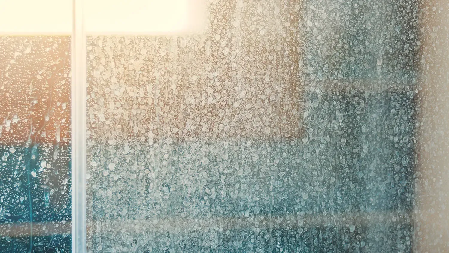 Mineral build up on glass that's in need of window cleaning.