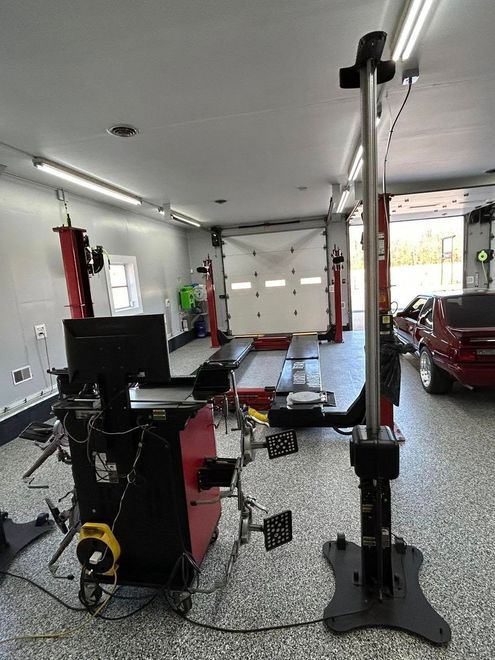 A Garage With a Lot of Tools and a Red Truck Parked in It | Independence Automotive Maintenance & Repair