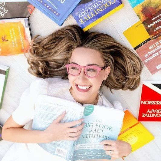 A woman is reading a book titled big book of fact metaphysics