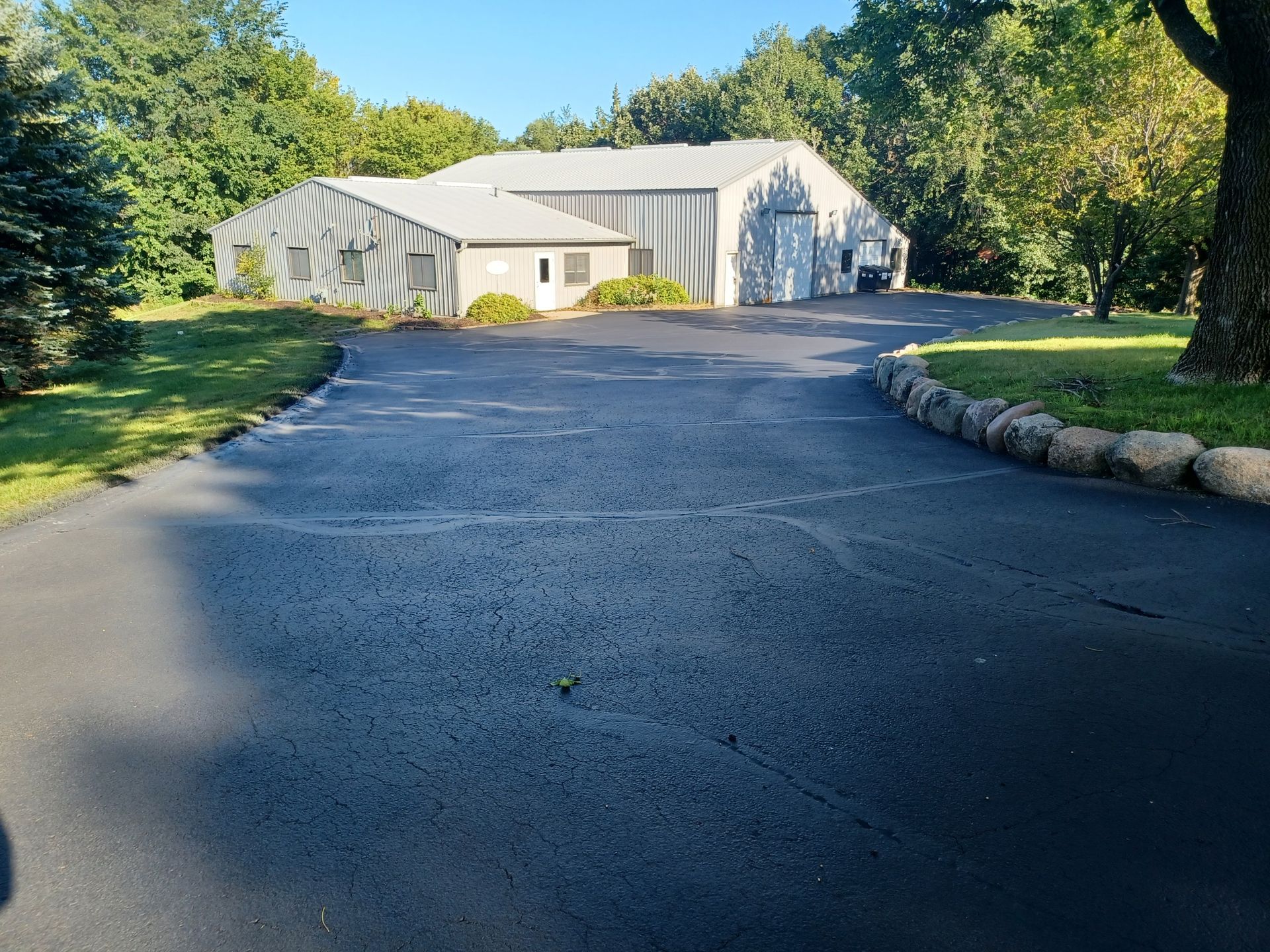 A driveway leading to a large white building