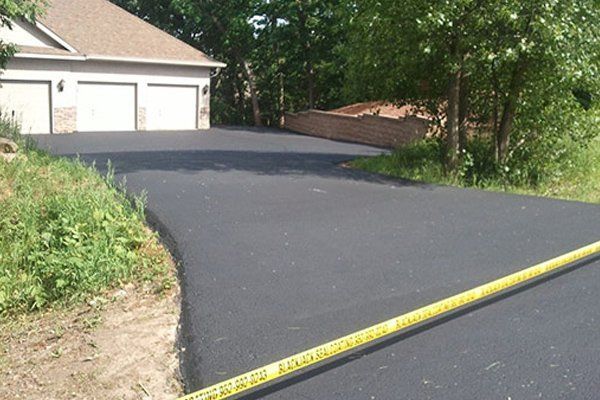A black road with a yellow tape that says 
