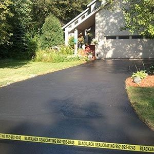 A driveway that has been sealed by blackjack sealcoating