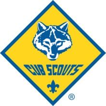 Cub Scout logo: blue raccoon face on yellow diamond with