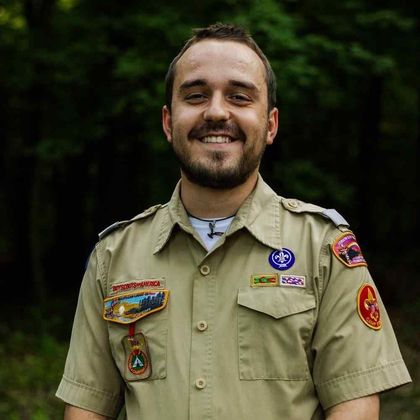 A close up of a person wearing a scout me ink shirt