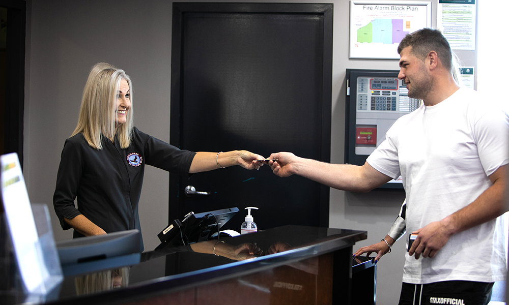 an  Albion Park Bowling Club staff member interacting with a customer