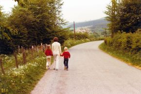 Family walking down a road Family walking down a road