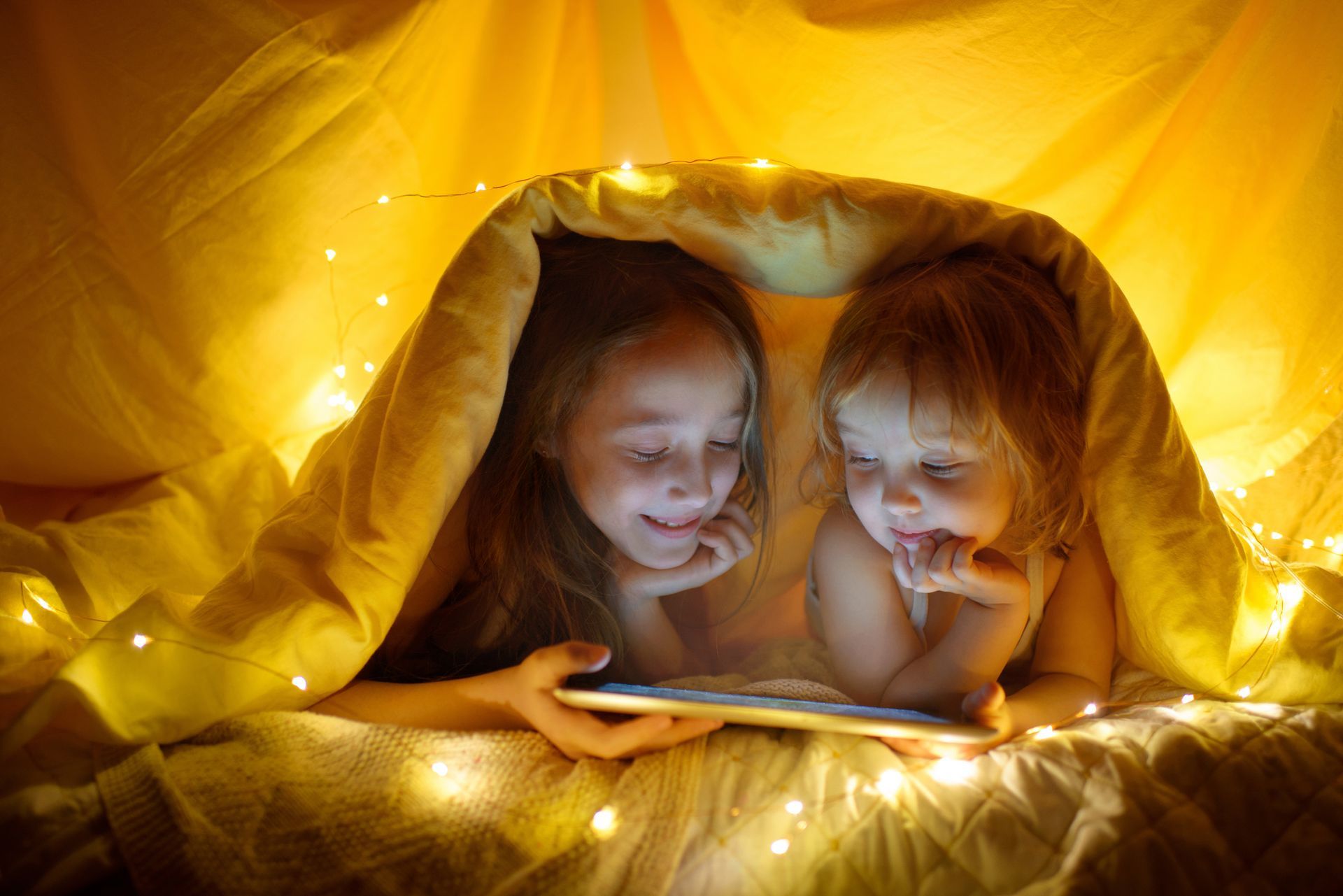 Family using a tablet and smartphone; app controls internet and devices.