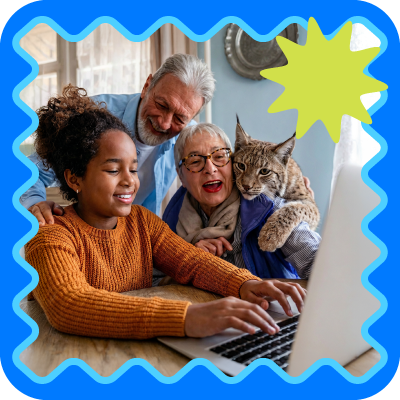 Smiling family with a cat gathered around a laptop in a cozy home setting