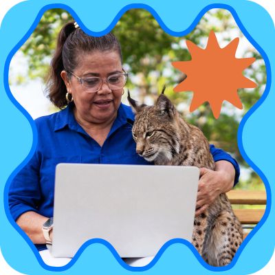 Woman in blue shirt using a laptop with a bobcat outdoors, framed by a blue wavy border and orange starburst.