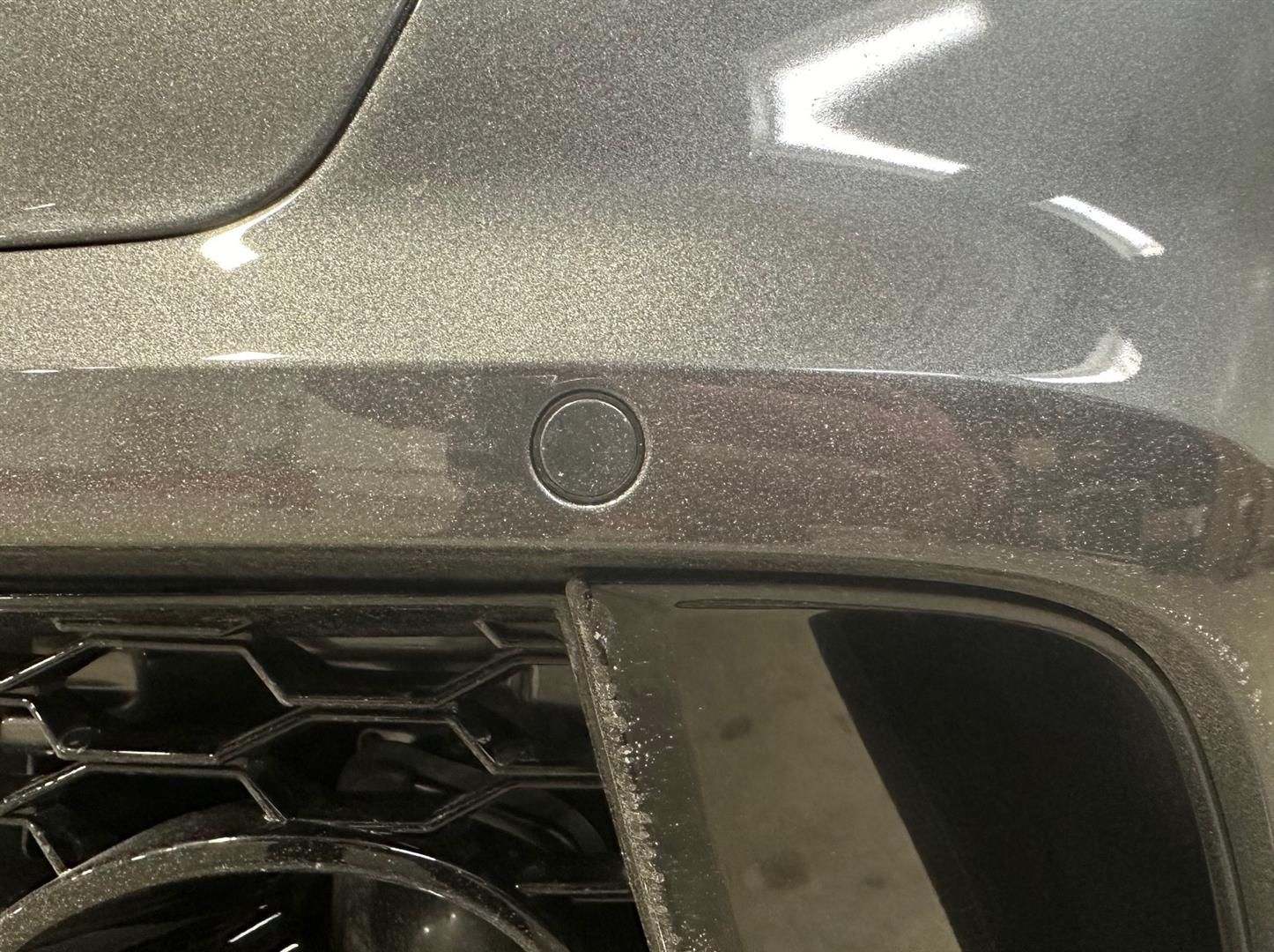 A close up of a parking sensor on the side of a car. | Lou's Car Care Center, Inc.