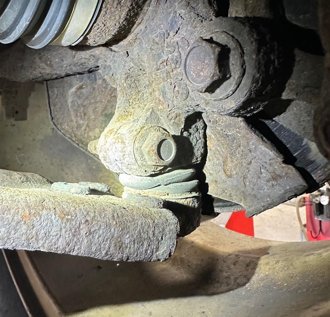 A close up of a rusty piece of metal on a car | Lou's Car Care Center, Inc.