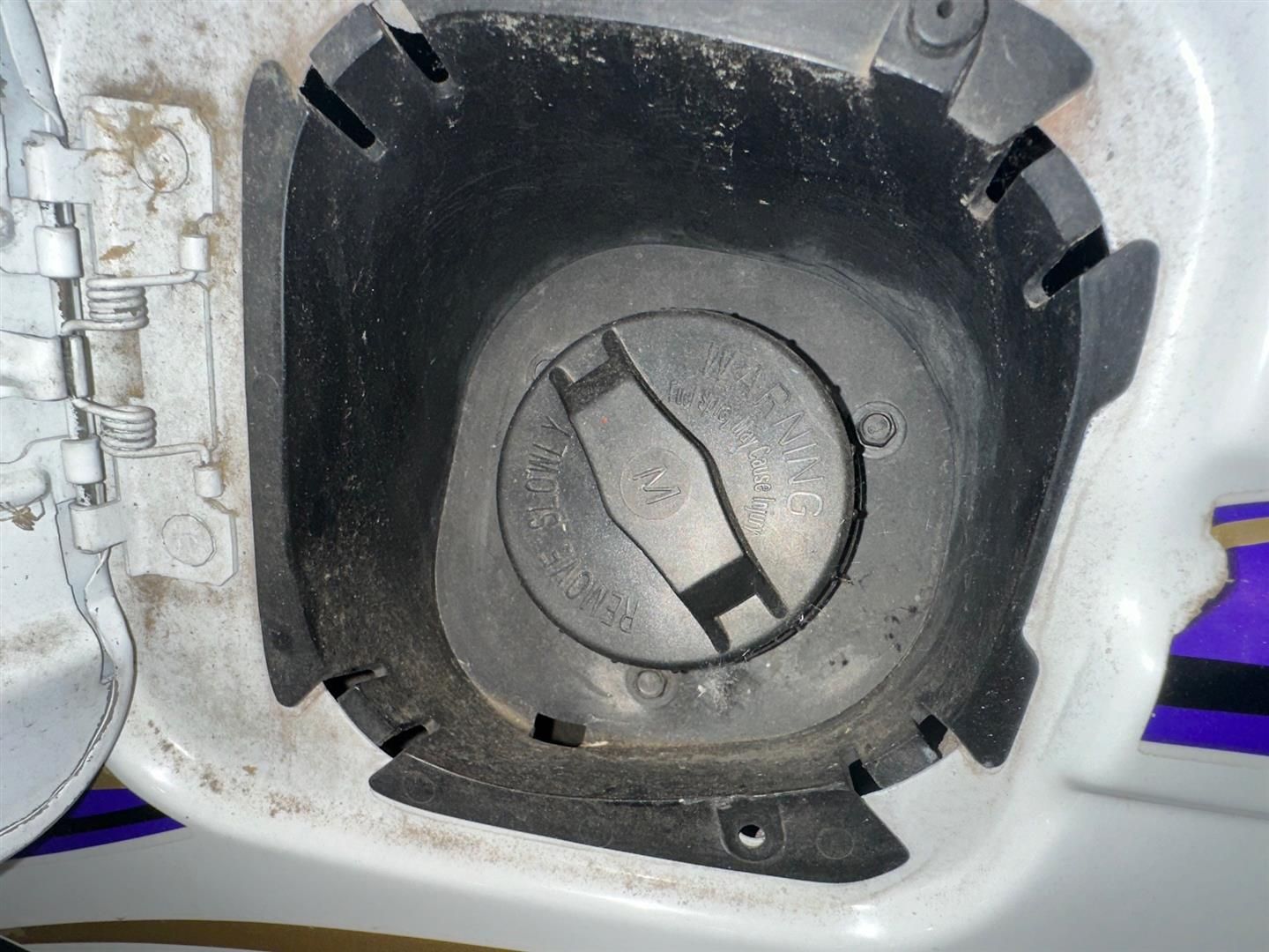 A close up of a fuel cap on a car | Lou's Car Care Center, Inc.