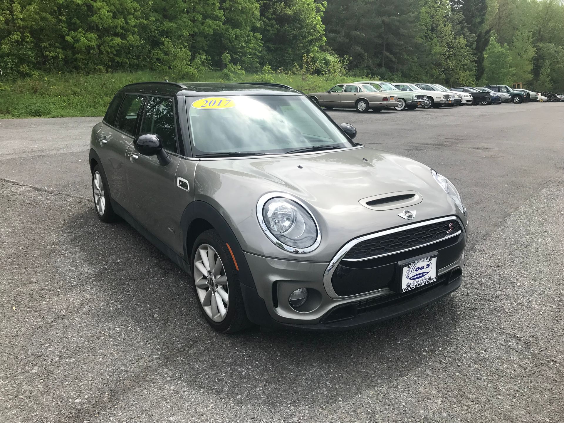 A gray mini cooper clubman is parked in a parking lot. | Lou's Car Care Center Inc.