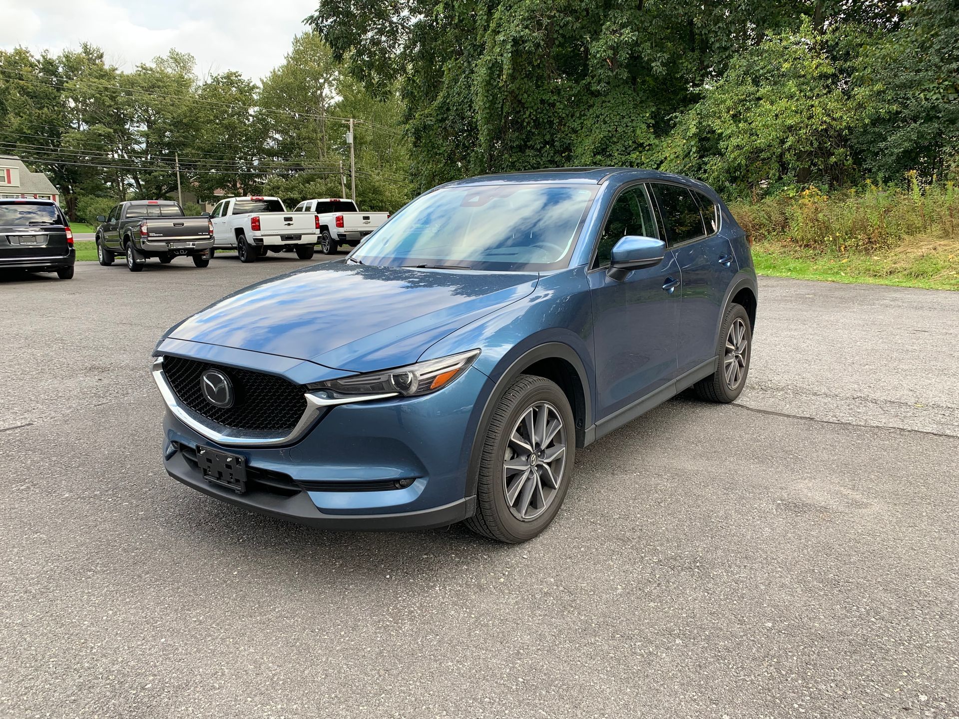 A blue mazda cx-5 is parked in a parking lot. | Lou's Car Care Center, Inc.