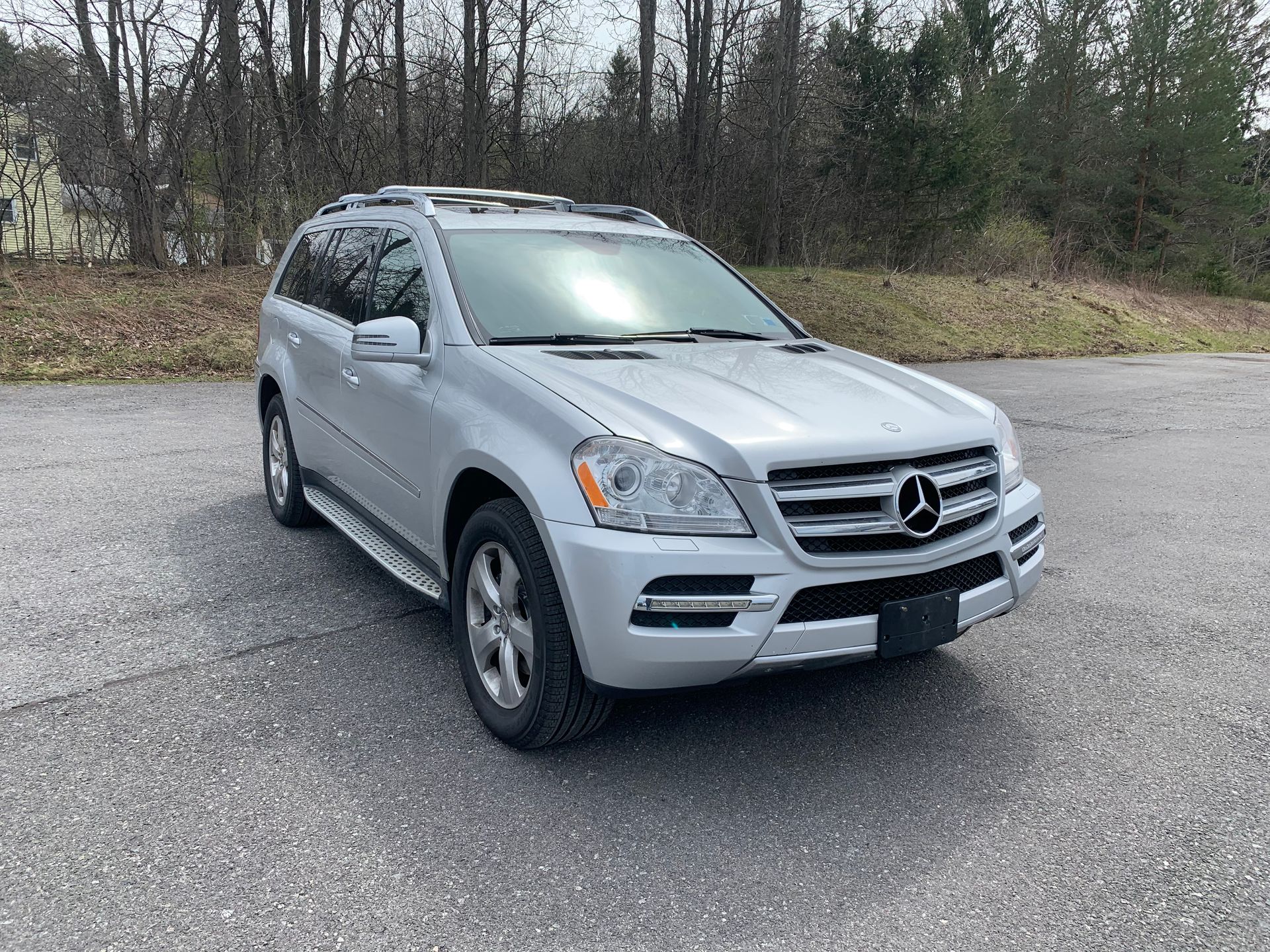 A silver mercedes benz gl 550 is parked on the side of the road.  | Lou's Car Care Center Inc.